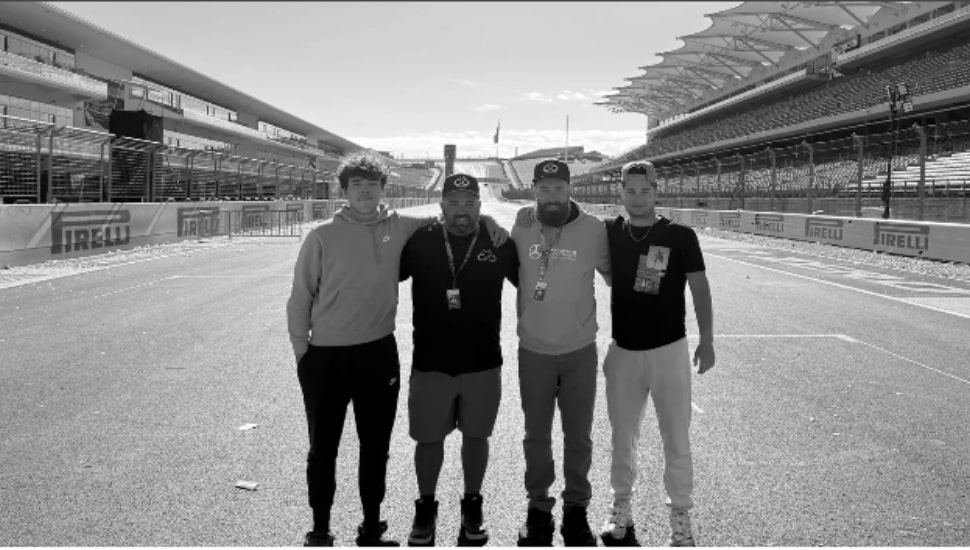 Four members of Endless Consulting's team members standing side-by-side in a black and white photo.