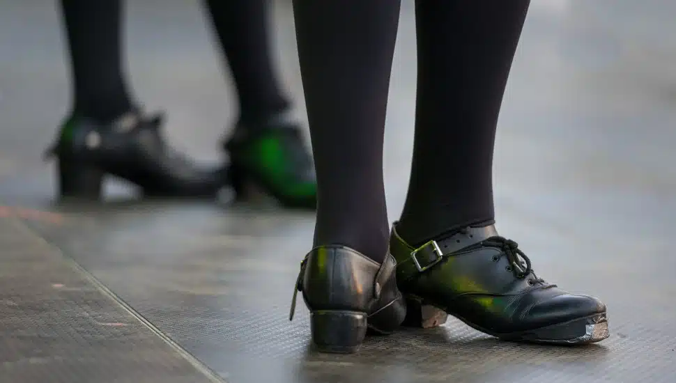 Two Irish dancers prepare to dance.