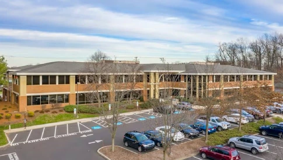 A wide view of the Jaisohn Community Wellness Plaza, showing the building, parking, and layout for easy access.