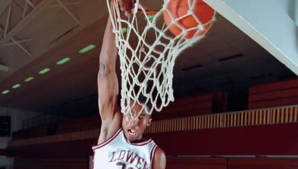 Kobe Bryant dunks a basketball in his Lower Merion uniform.