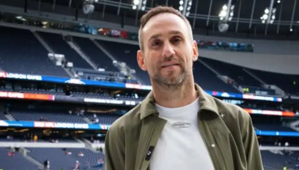 Michael Rubin stands on the pitch at a soccer game.