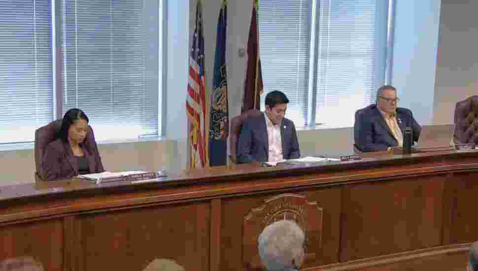 Montgomery County Commissioners Jamila Winder, Neil Makhija and Tom DIBello sit at a meeting.