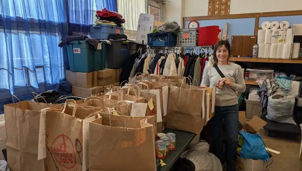 A volunteer packs food and ingredients to donate for Thanksgiving dinners.