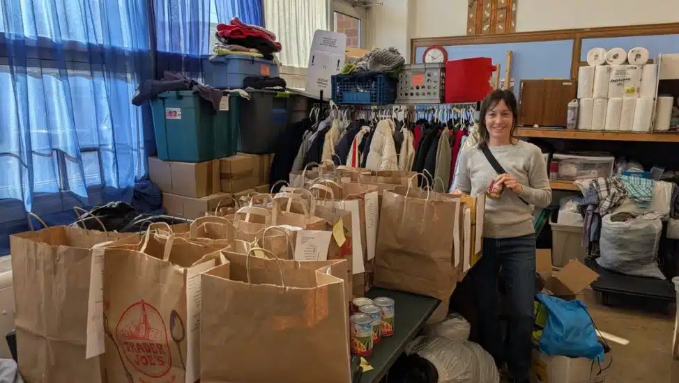 A volunteer packs food and ingredients to donate for Thanksgiving dinners.