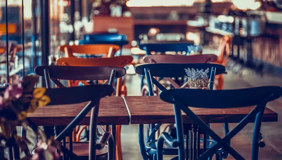 An empty table sits in a restaurant dining room.
