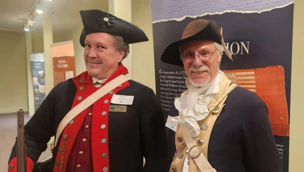 Two men wearing Revolutionary Era clothes.