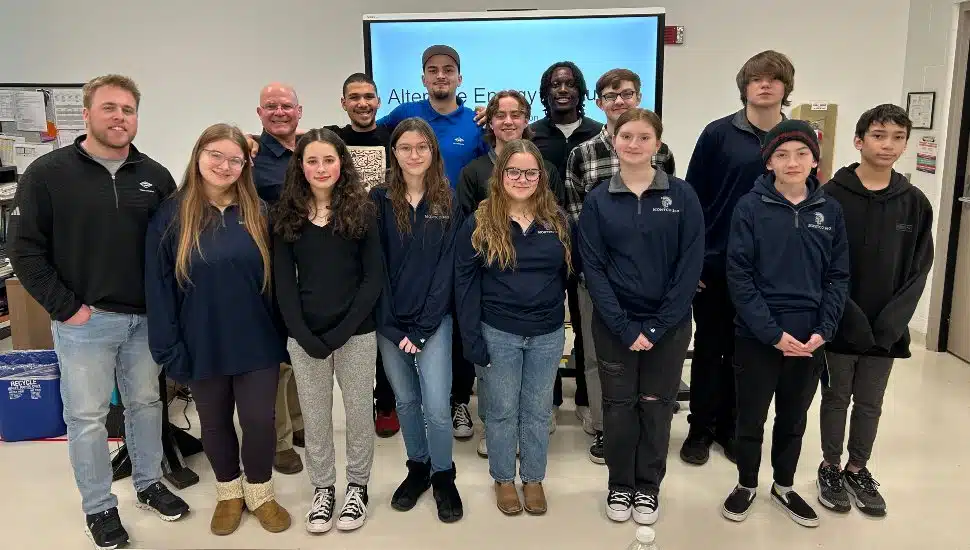 Eighteen Pottstown Middle School eighth graders in the Montco 360 program pose with instructors after presenting renewable energy machine prototypes at Montgomery County Community College’s Pottstown Campus.