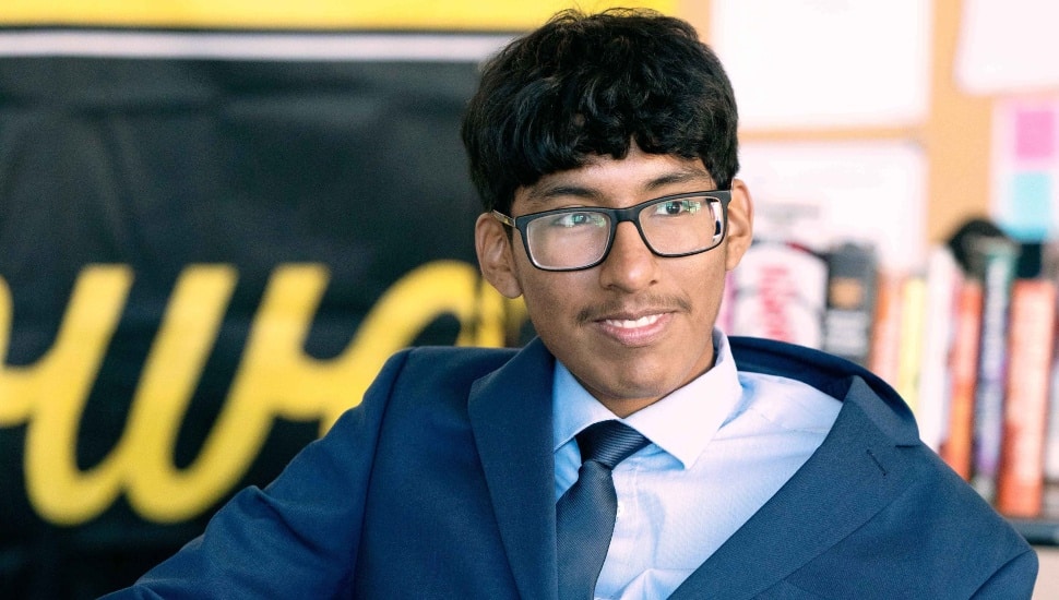 Male high school senior in glasses and blue suit.