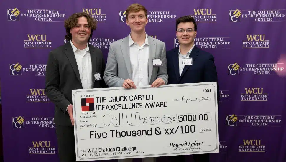 West Chester University students hold a $5,000 Chuck Carter IdeaXcellence Award check at the WCU Business Idea Challenge.