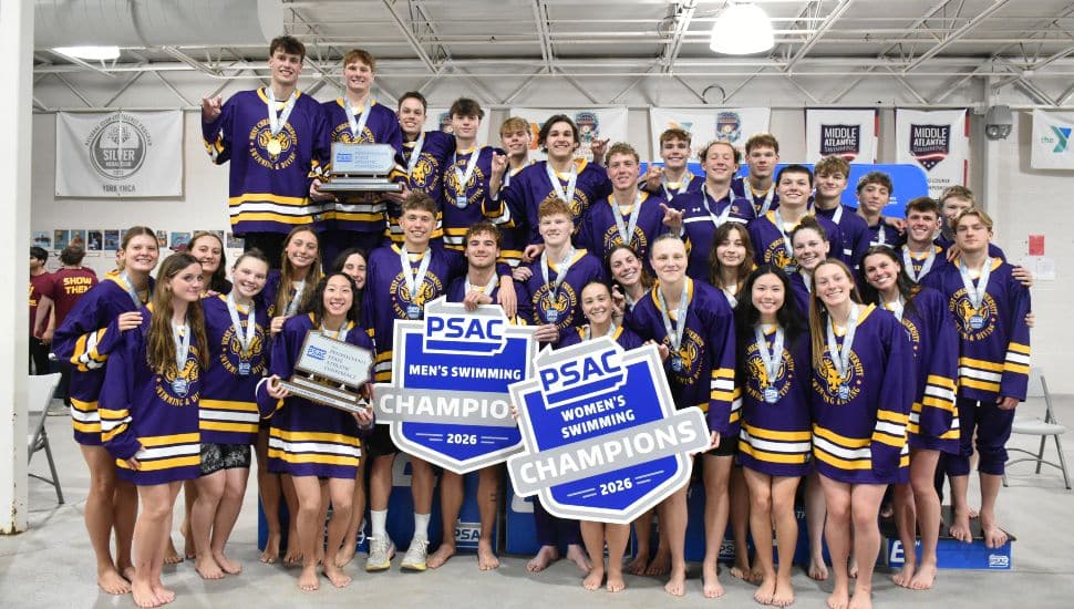 West Chester University men’s and women’s swimming teams celebrate 2026 PSAC Championships with trophies and champion signs at York YMCA Graham Pool.