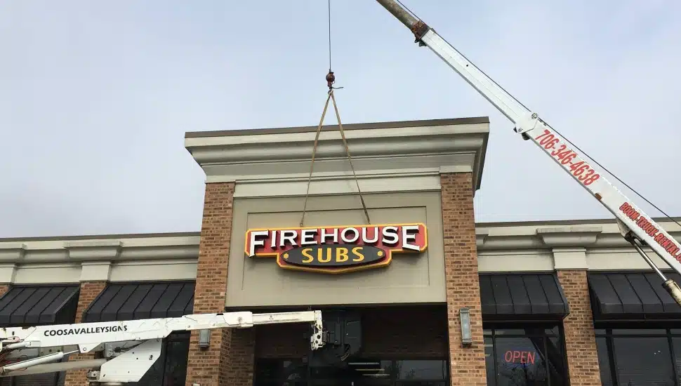 A Firehouse Subs sign erects over a new location.