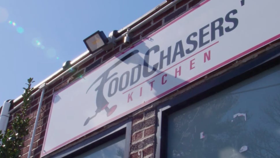A look up at the outdoor FoodChasers sign.