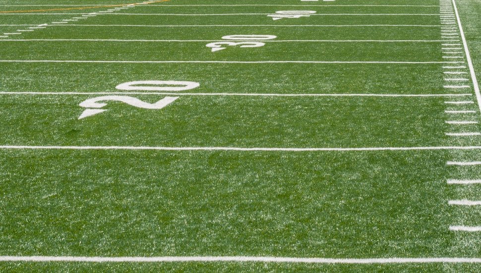 White markers line a high school football field.