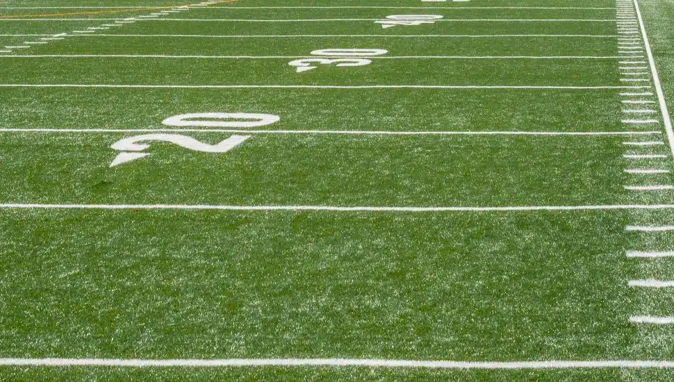 White markers line a high school football field.
