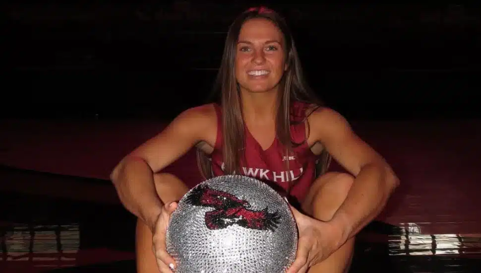 Gabby Casey holds a bedazzled St. Joe's basketball.