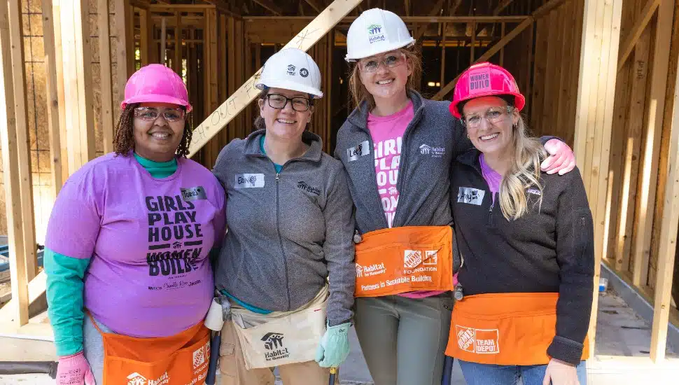Women volunteers work on the site of a Habitat for Humanity construction site.