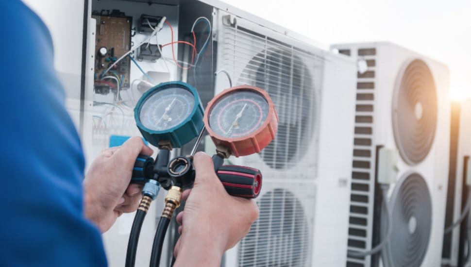 Technician is checking air conditioner,measuring equipment for filling air conditioners.