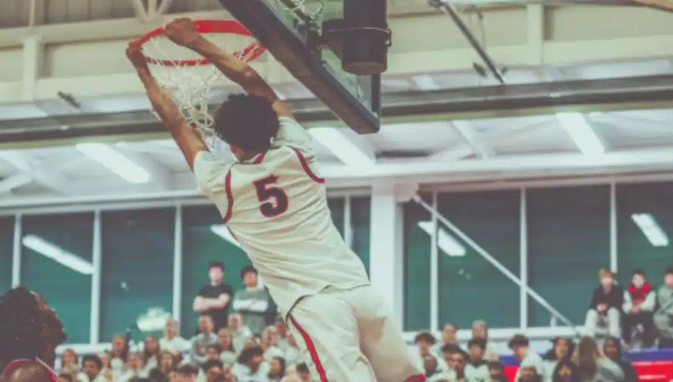 Mani Sajid dunks a basketball.