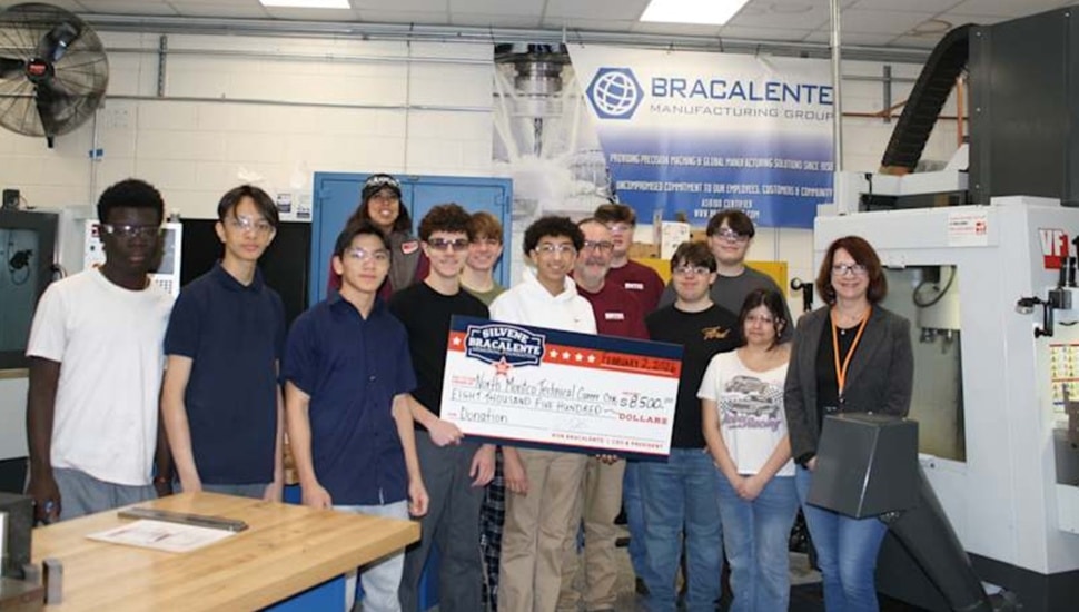 Students receive giant check.