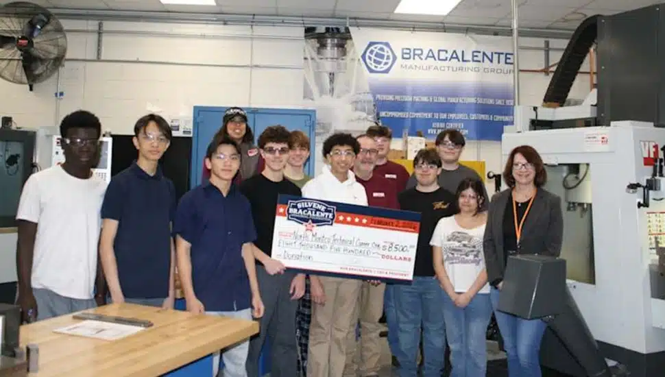 Students receive giant check.