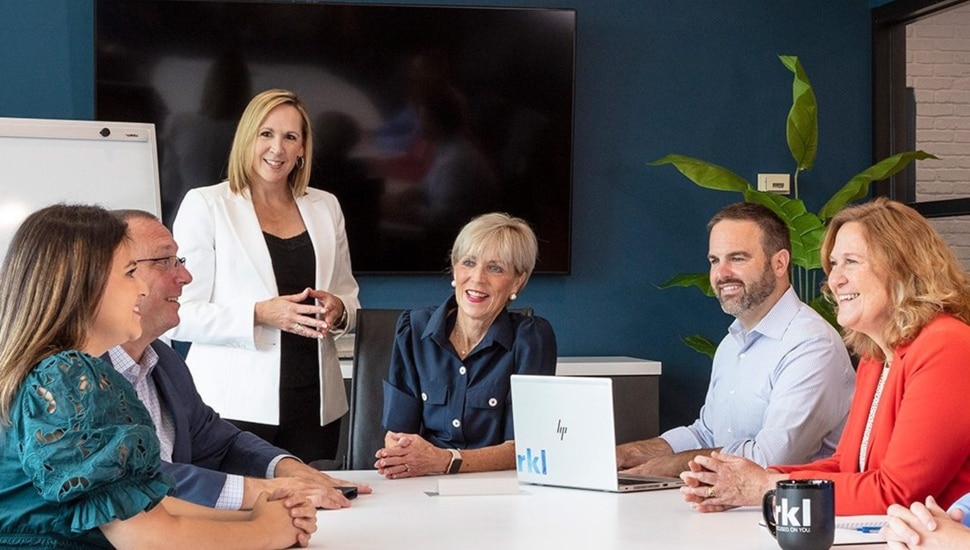 Accounting professionals work in conference room.