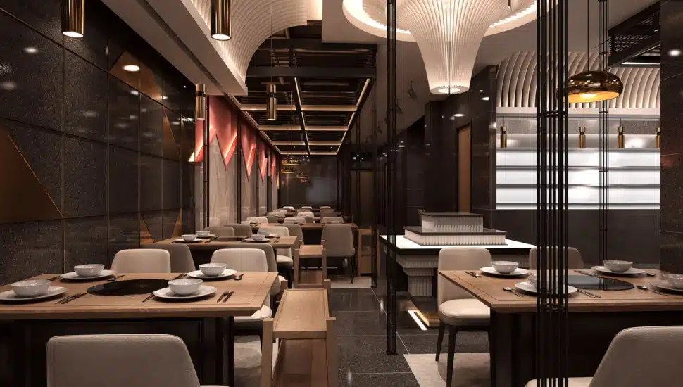 An empty restaurant dining room with moody lighting.