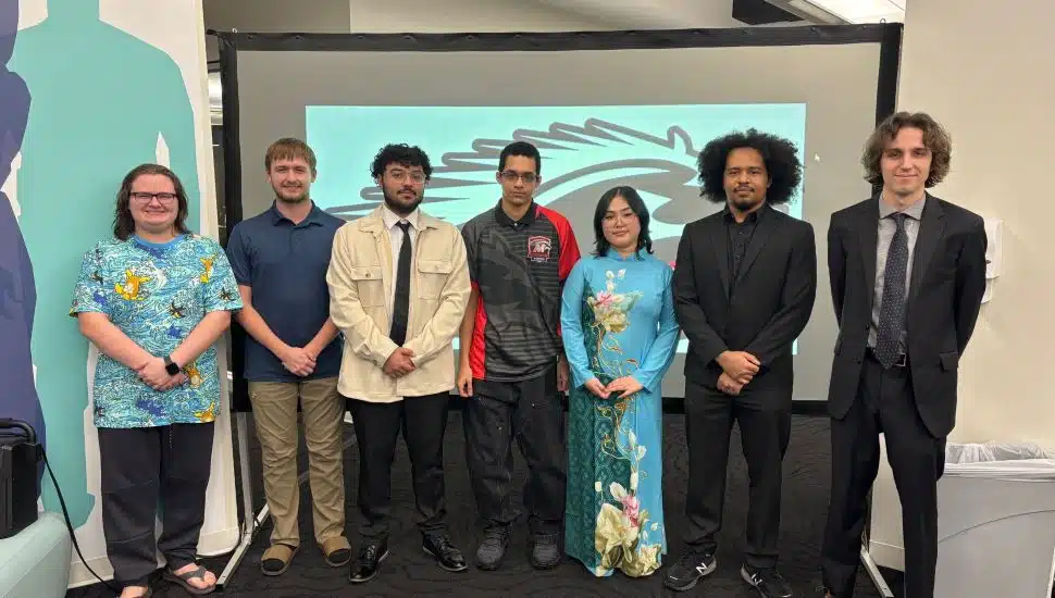 (From left) Colin Colin Krotzer, Kyle Boos, Daniel Rosa Jr., Lawrence Wood, Hannah Hang, Truman Irizarry and Coach Jace Winders earned Eastern College Athetic Conference national title for the Mustangs eSports team in “Overwatch.” It was one of three titles the Mustangs earned for the program during the fall 2025 semester.