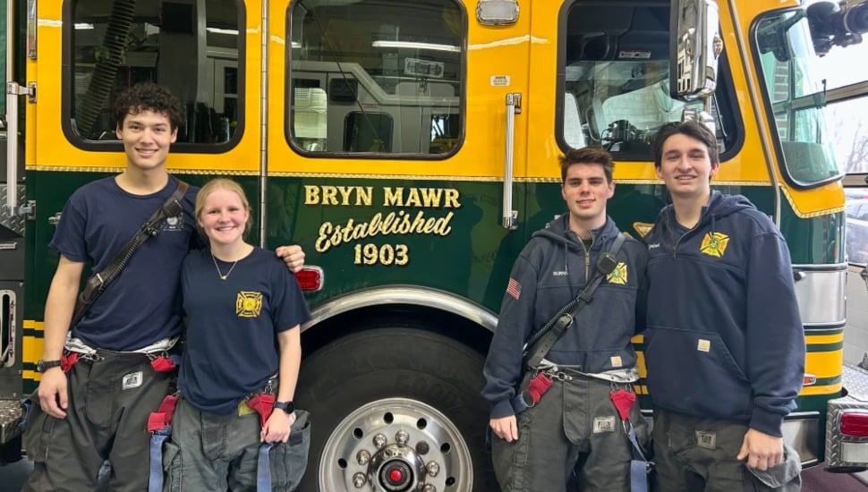 Villanova students Colton Musselman, Anne Earp, John Burns, and Dominic Cipriani stand in front of a Bryn Mawr Fire Company engine.