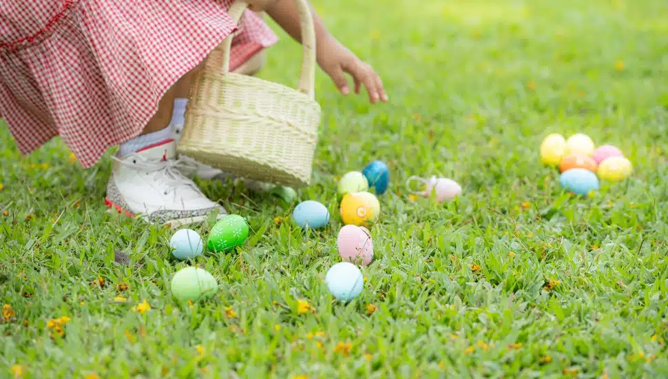 Girl enjoying outdoor activities in the park including a run to collect beautiful Easter eggs.