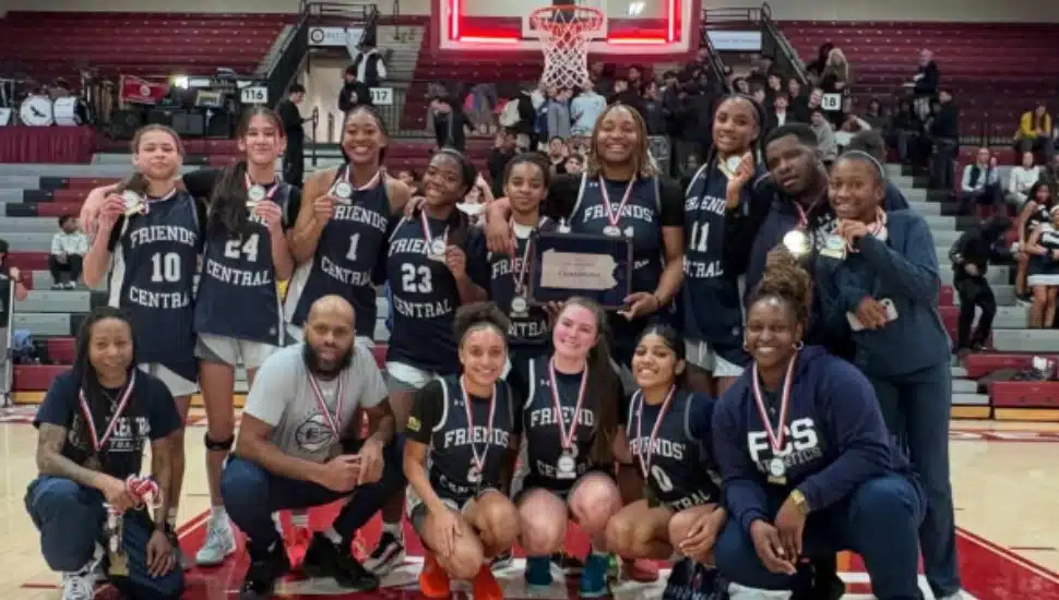 The Friends Central School girls basketball team poses on the court after PAISAA win.