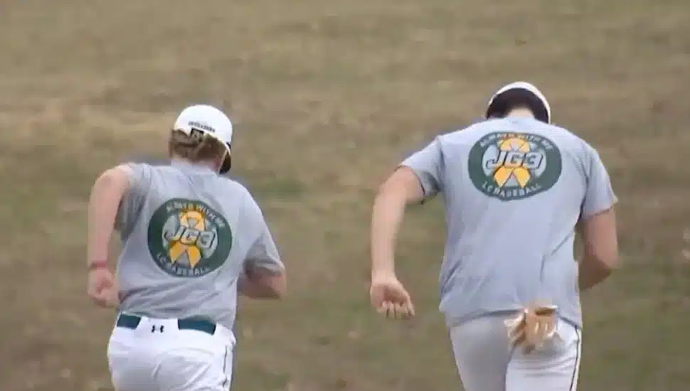 Lansdale Catholic players run onto the field wearing JG 3 shirts.