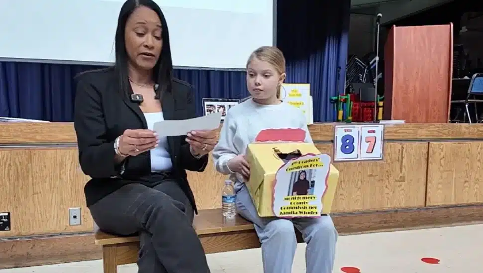 Jamila Winder sits with a student answering questions at Penn Wynne Elementary.