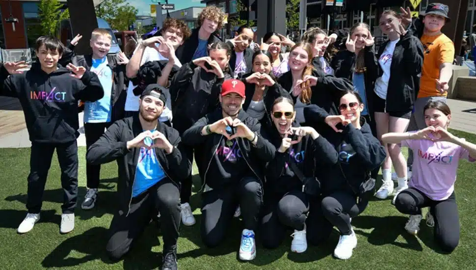 Young people make heart gestures with their hands.