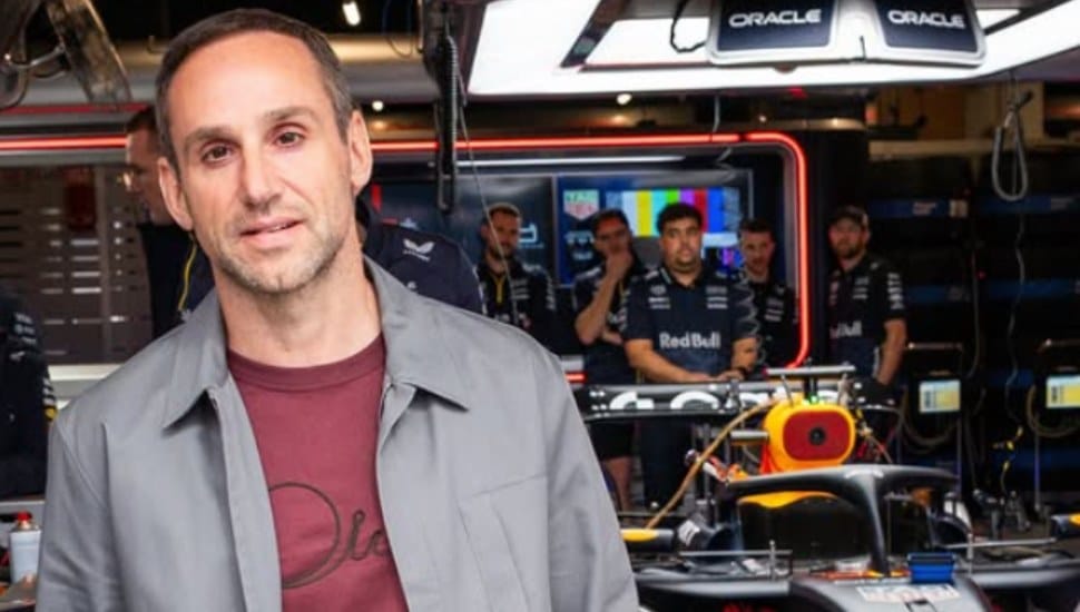 Michael Rubin stands in a Formula One garage.