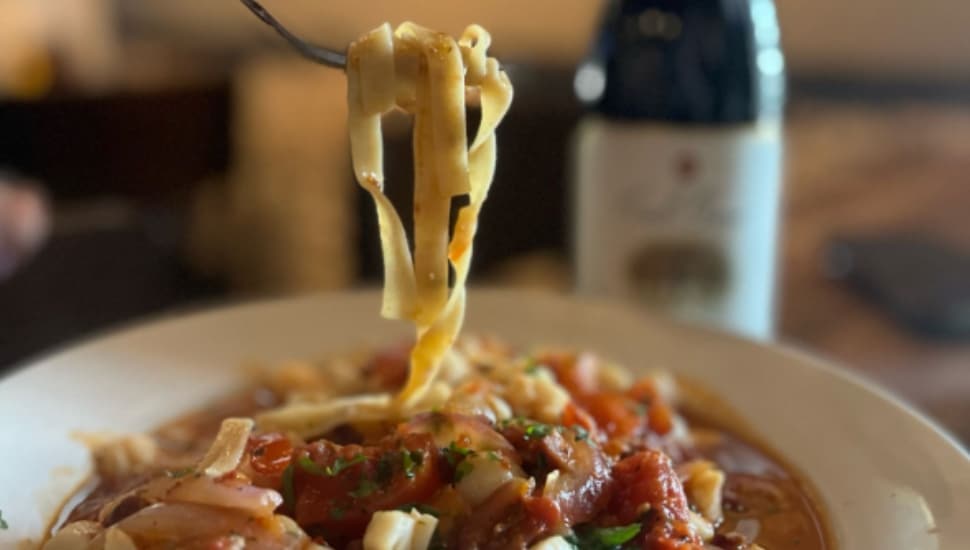 A fork lifts pasta from a dish at Pepperoncini.