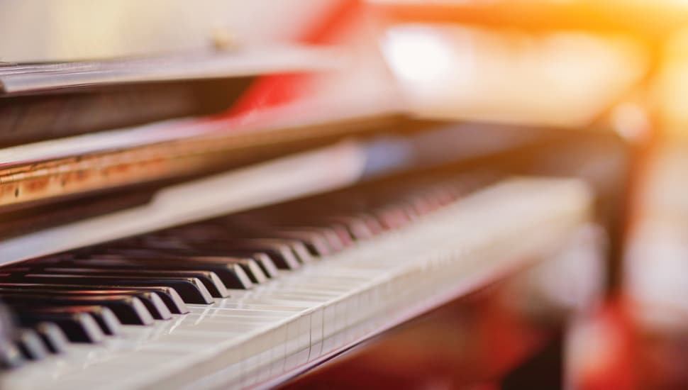 Beautiful piano background are set by the window in the morning waiting for the pianist to come to practice in the morning to reduce the mistake of having to perform the piano performance at a concert