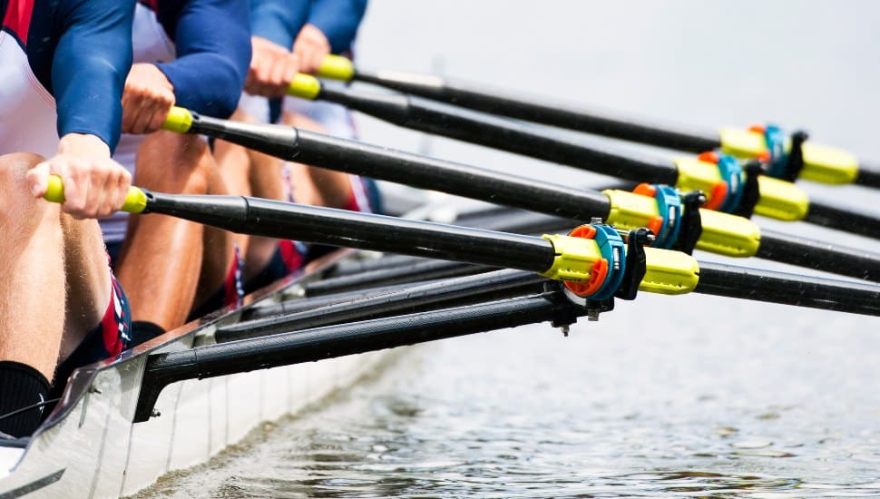 Close up of a men's quadruple skulls rowing team, seconds after the start of their race.