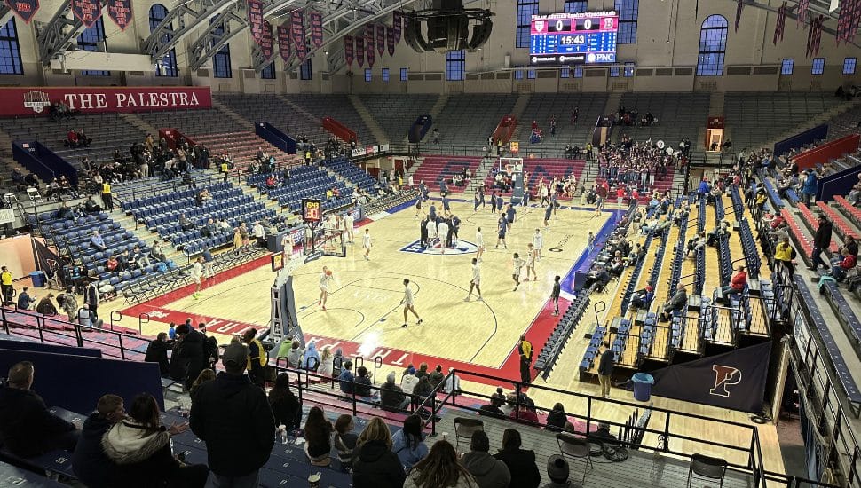 A basketball game and crowd inside The Palestra.