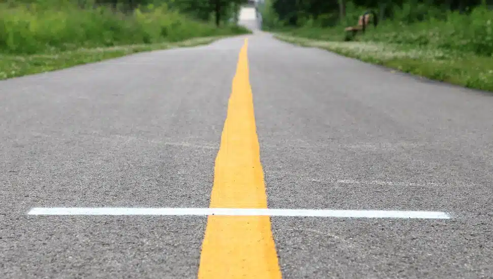 Yellow lines stretch a bike trail.
