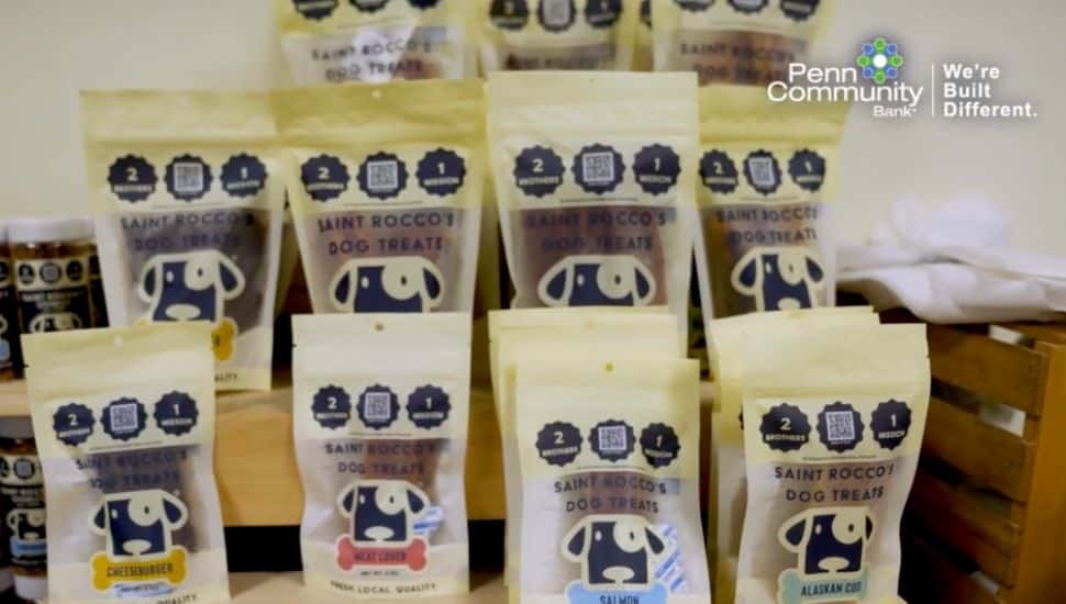 Saint Rocco’s Treats packaged dog treats with Penn Community Bank logo at top.