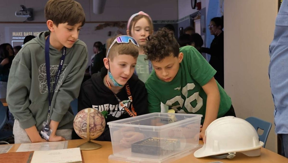 Middle school students work on astronomy project.