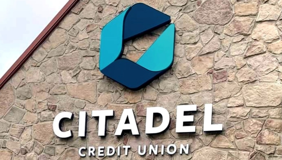Credit union's signage on stone building.