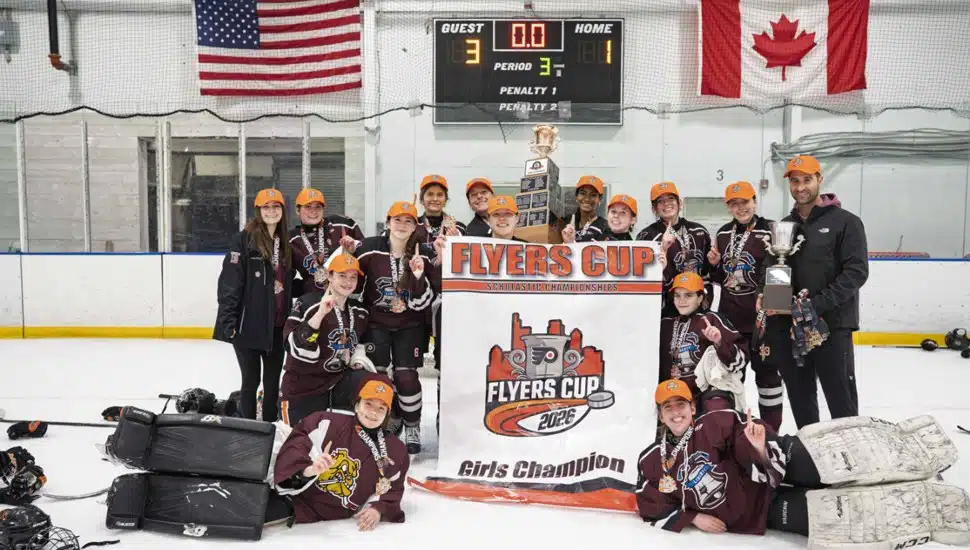 The Lower Merion Liberty women's ice hockey team poses with the Flyers Cup.