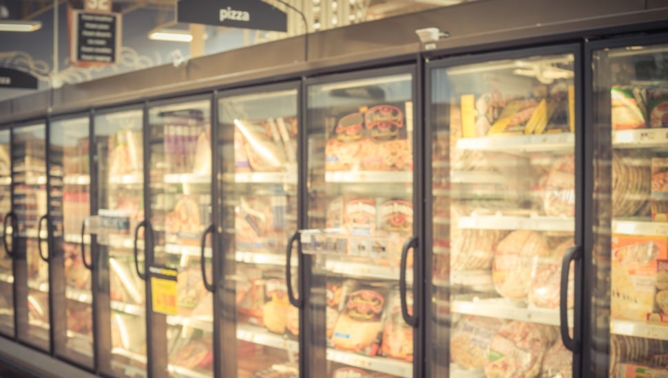 Frozen pizza aisle in grocery store.