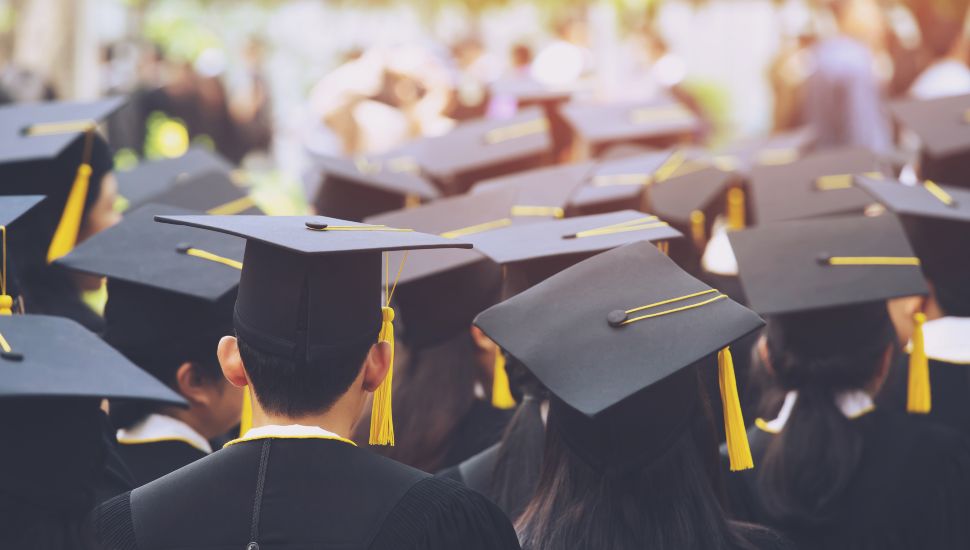 Students gather at a graduation ceremony.