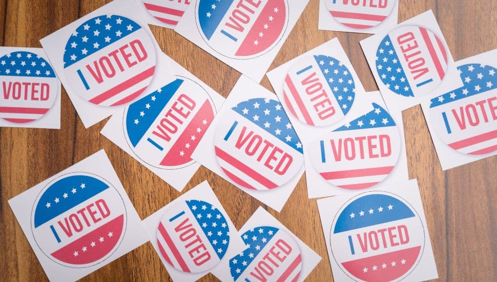 Multiple I Voted stickers on table.