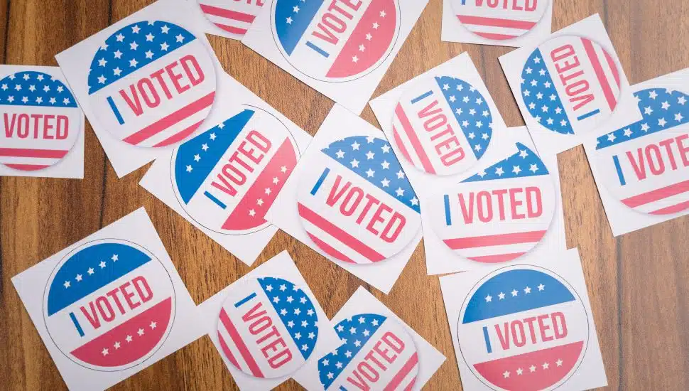 Multiple I Voted stickers on table.
