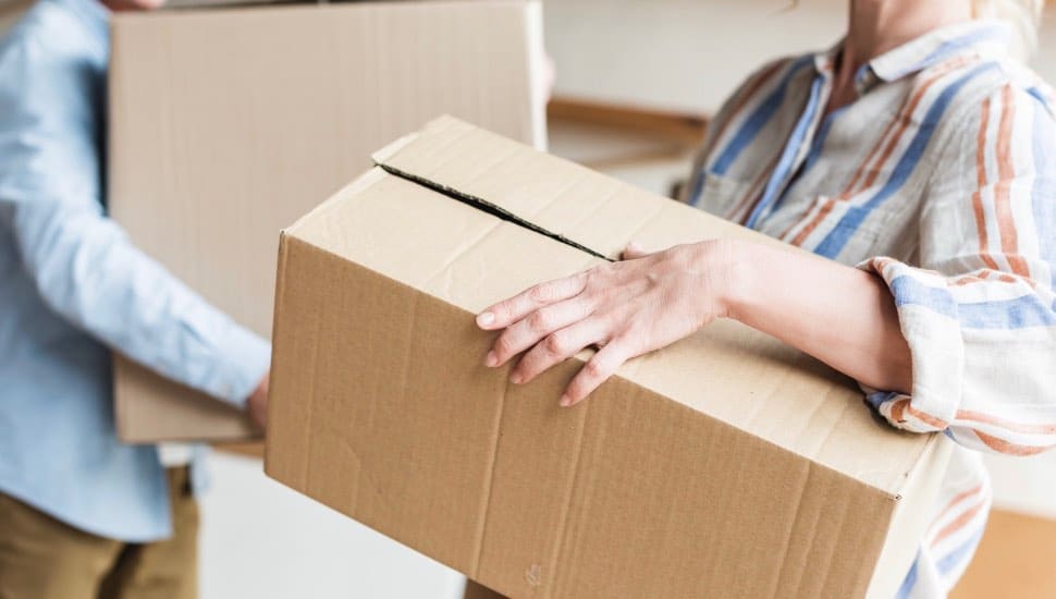Seniors pack boxes in preparation of a move.