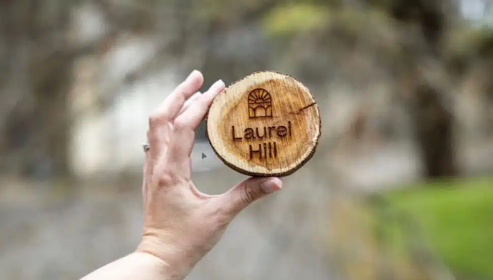 The Laurel Hill Cemetery design burned into a piece of the fallen English yew tree.