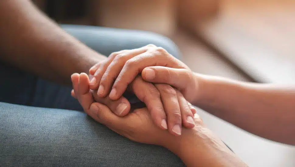 Person holding another person's hand.